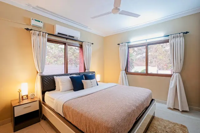 King bedroom with bedside lamps and air conditioning